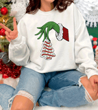 Comfort Colors® Grinch hand Holding Little Debbies Christmas Tree Cake T-Shirt, Faux Yarn 3D Holiday sweatshirt, Christmas Gift Shirt, Matching family T-Shirt Holiday matching family knit look /  FYP Viral Trending Sweatshirts / Funny Holiday Crewneck